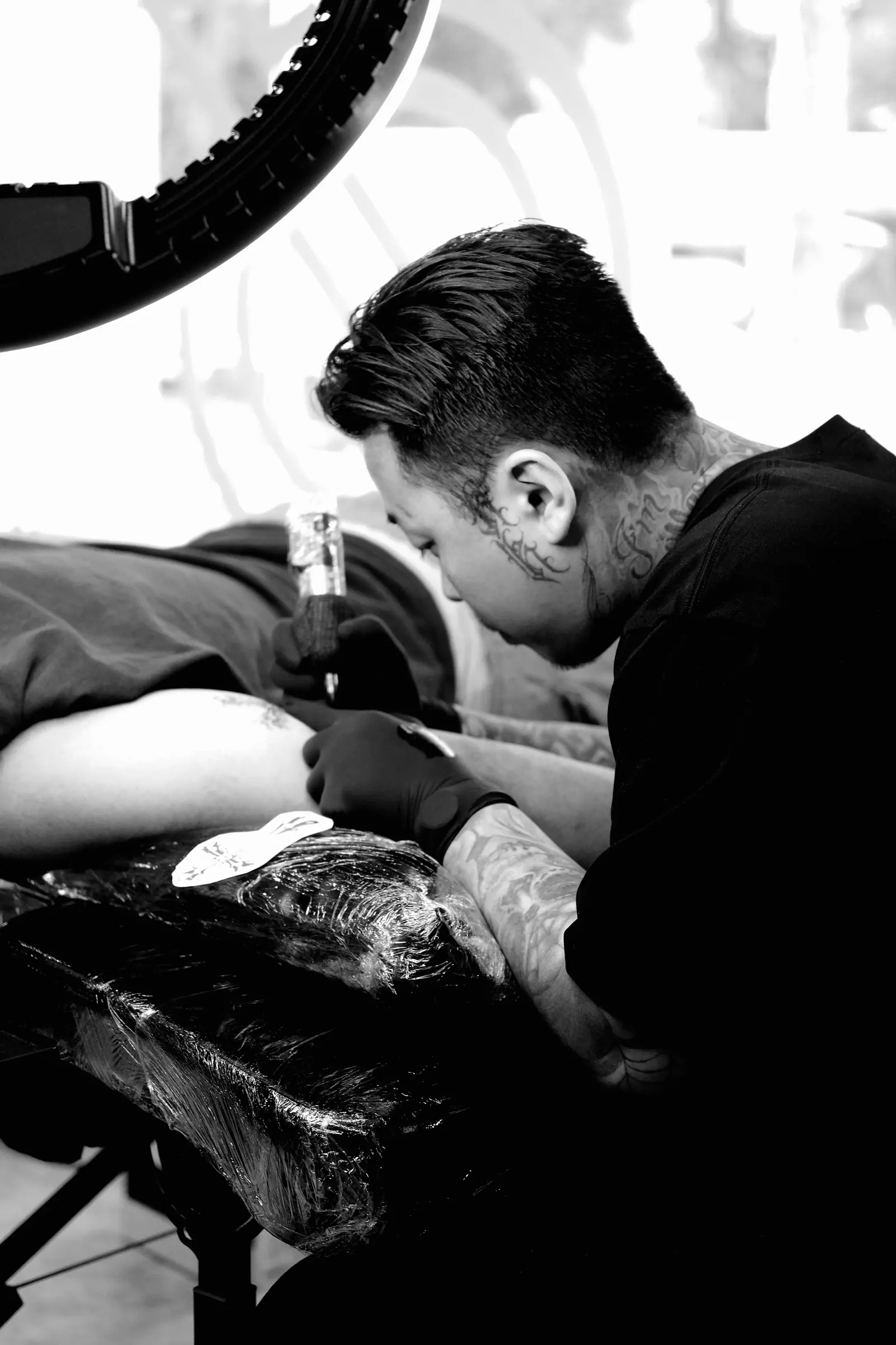 Creed tattooing a client in Seoul